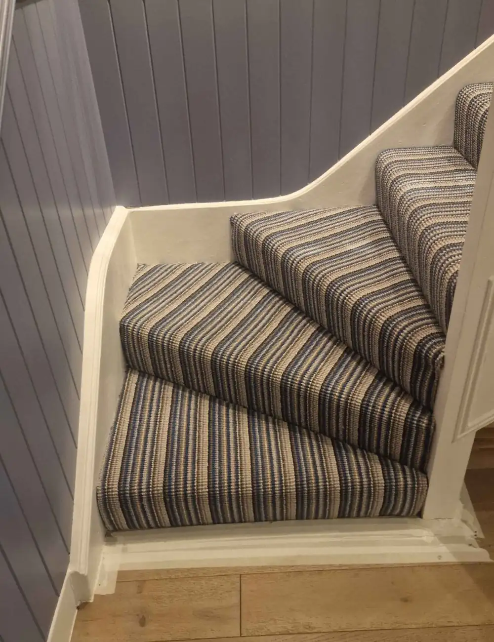 Striped stair carpet runner installation in Dubai